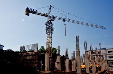 Photo by novila misastra a construction site with a crane in the background